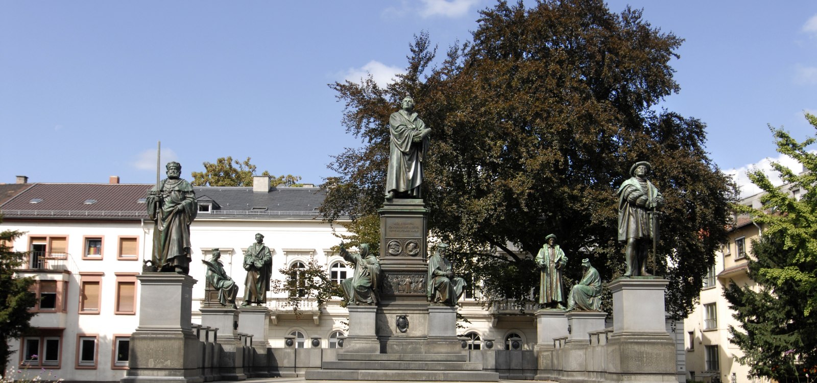 The picture depicts the Luther Monument in Worms. The sculpture represents the reformer Martin Luther, who spoke his famous words before the Imperial Diet in Worms in 1521: &quot;Here I stand, I can do no other. God help me. Amen.&quot; The monument is an impressive testament to historical events and a significant site in Worms.